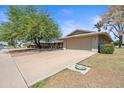 View of the garage and front of the home, with a well-maintained driveway and landscaping at 14633 N Boswell Blvd, Sun City, AZ 85351