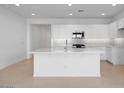 Spacious kitchen with white cabinets, stainless steel appliances, a center island, and modern backsplash at 14777 W Soft Wind Dr, Surprise, AZ 85387