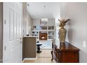 Open entryway leads to the living area featuring stylish décor, tile floors, and a cozy fireplace at 1589 E Manor Dr, Casa Grande, AZ 85122
