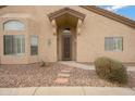 Inviting front entrance features a decorative security door, beautiful landscaping, and stepping stone walkway at 1589 E Manor Dr, Casa Grande, AZ 85122