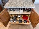 Kitchen island cabinets featuring pull-out shelves for organized cookware and convenient access at 16423 N 41St Pl, Phoenix, AZ 85032
