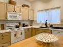 Well-equipped kitchen with modern appliances, wooden island, quartz counters, and ample cabinet space at 16545 E Gunsight Dr # 103, Fountain Hills, AZ 85268