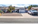 Charming single-story home with a well-maintained gravel front yard and a driveway leading to an attached garage at 1825 E Kings Ave, Phoenix, AZ 85022