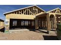 A home under construction, showing the wood framework and open garage at 2088 E Bucking Bronco Dr, San Tan Valley, AZ 85140