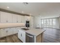 Modern kitchen offers white cabinets, stainless appliances, island with sink, and open floor plan at 2121 W Sonoran Desert Dr # 45, Phoenix, AZ 85085