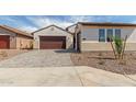 Single-Gathering home showcasing brick driveway, manicured yard, and a two-car garage at 25215 N 131St Dr, Peoria, AZ 85383