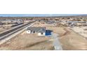 A single-story home with a gray tiled roof sits on a large lot ready for landscaping at 30634 W Latham St, Buckeye, AZ 85326