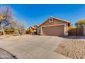 Single-story house with desert landscaping, concrete driveway leading to a two-car garage under a blue sky at 4044 E Cascalote Dr, Cave Creek, AZ 85331