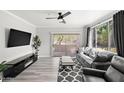 Modern living room with a fireplace, sleek furniture, and access to an outdoor patio at 5345 E Van Buren St # 141, Phoenix, AZ 85008