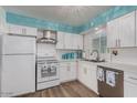 Bright kitchen features white cabinets, stainless steel appliances, subway tile backsplash, and wood-look flooring at 6224 E Decatur St, Mesa, AZ 85205
