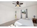 Cozy main bedroom with a ceiling fan, neutral carpeting, and an ensuite bathroom at 6224 E Decatur St, Mesa, AZ 85205