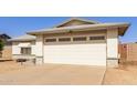 Home featuring a large garage door and concrete driveway at 7220 W Medlock Dr, Glendale, AZ 85303