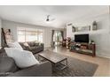 Inviting living room with neutral paint, tile flooring, and comfortable seating at 7220 W Medlock Dr, Glendale, AZ 85303