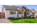 Charming single-Gathering home with a lush, green lawn, gravel driveway, and stylish exterior at 7525 E Latham St, Scottsdale, AZ 85257