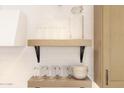Close up on kitchen shelving, showing modern decor, tableware, and cabinets at 7993 W Griswold Rd, Peoria, AZ 85345