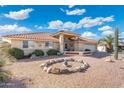 Inviting single-story home with desert landscaping, a rock garden, covered entrance and attached garage at 8303 E Monterey Ave, Mesa, AZ 85209