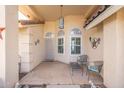 Cozy front porch featuring seating, desert decor, and a welcoming entrance with tiled roofing at 8303 E Monterey Ave, Mesa, AZ 85209