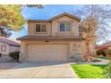 Two-story home with a two-car garage, green grass, and desert landscaping at 1043 W Washington Ave, Gilbert, AZ 85233