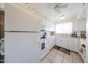 Bright kitchen featuring white appliances, a garden window, and ceiling fan at 10846 N Fairway E Ct, Sun City, AZ 85351