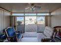 Relaxing sunroom with ample natural light, ceiling fan, and views of the surrounding landscape at 10846 N Fairway E Ct, Sun City, AZ 85351