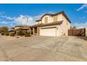 Two story home featuring a front yard, neutral color scheme, and a two-car garage at 11128 E Segura Ave, Mesa, AZ 85212