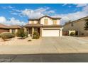 Two story home featuring a front yard, neutral color scheme, and a two-car garage at 11128 E Segura Ave, Mesa, AZ 85212