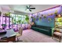 Bright living room featuring a green sofa, large windows, and plenty of plants for a natural aesthetic at 13845 N 41St Ave, Phoenix, AZ 85053