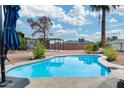 Backyard pool with patio and desert landscaping under a bright sunny sky at 13845 N 41St Ave, Phoenix, AZ 85053