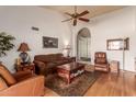 Cozy living room showcasing hardwood floors, a ceiling fan, an arched doorway, and comfortable seating at 14718 W Ravenswood Dr, Sun City West, AZ 85375