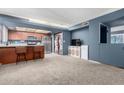 Inviting living room featuring carpet flooring and a kitchen bar, great for entertaining at 1578 W Campbell Ave, Phoenix, AZ 85015