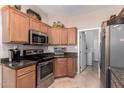 Functional kitchen area offering granite countertops and modern stainless steel appliances at 16600 N Thompson Peak Pkwy # 1052, Scottsdale, AZ 85260