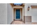 Close-up of the front entrance featuring a stylish blue door and welcoming entryway at 16778 W Yucatan Dr, Surprise, AZ 85378
