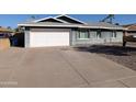 Single-story home featuring a two car garage with a wide driveway at 1708 E Wesleyan Dr, Tempe, AZ 85282