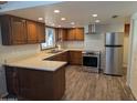 Well-lit kitchen showcasing wood cabinetry, stainless steel appliances, and modern countertops at 1708 E Wesleyan Dr, Tempe, AZ 85282