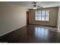 Bright living room features hardwood floors and a large window with shutter blinds at 1708 E Wesleyan Dr, Tempe, AZ 85282