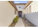 Inviting entryway with beautiful landscaping, a decorative door, and a charming walkway at 17634 W Verdin Rd, Goodyear, AZ 85338