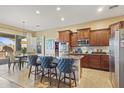 Stylish kitchen with stainless steel appliances, granite countertops, and a breakfast bar with seating at 17634 W Verdin Rd, Goodyear, AZ 85338