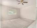 Bright bedroom featuring neutral carpet, a ceiling fan, and a window providing natural light at 18002 N 135Th Dr, Sun City West, AZ 85375