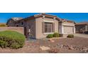 Landscaped front yard with desert-scape, decorative rocks, and manicured bushes in front of a single story home at 18750 E Ryan Rd, Queen Creek, AZ 85142