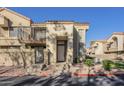 Inviting condo featuring a private balcony, gated entry, and desert landscaping for relaxed living at 1905 E University Dr # 219, Tempe, AZ 85288