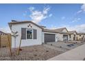 Lovely home featuring desert landscaping, neutral colors, and a two-car garage at 21250 E Sparrow Dr, Queen Creek, AZ 85142