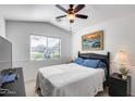 Bright bedroom with large window, ceiling fan, and neutral décor at 24204 N 27Th Pl, Phoenix, AZ 85024