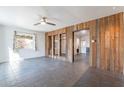 Inviting living room featuring tile floors, wood paneled walls, and bright natural light at 3027 N 21St Pl, Phoenix, AZ 85016