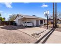 Single story home with a carport and a basketball hoop on the driveway, under a blue sky with white clouds at 3031 S Los Altos --, Mesa, AZ 85202