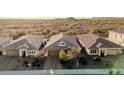 A panoramic view of three single-story homes in a desert community, showcasing their tile roofs at 30816 N 138Th Ave, Peoria, AZ 85383