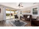 Comfortable living room with a ceiling fan, leather furniture, and sliding doors to the patio at 30816 N 138Th Ave, Peoria, AZ 85383