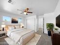 Relaxing main bedroom featuring plush carpet, neutral tones, a ceiling fan, and ample natural light at 3201 W Five Mile Peak Dr, San Tan Valley, AZ 85144