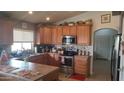 Charming kitchen with wooden cabinets, tile backsplash, and stainless steel appliances at 34734 N Happy Jack Dr, San Tan Valley, AZ 85144