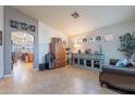 Spacious living room with tile floors, neutral walls, arched doorway, and a display of decor at 34734 N Happy Jack Dr, San Tan Valley, AZ 85144