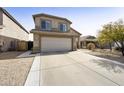 Two-story home with long driveway and a two car garage, in a desert landscape at 4439 E Coyote Wash Dr, Cave Creek, AZ 85331